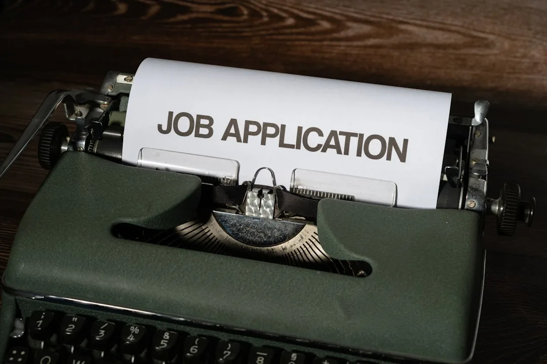 Vintage typewriter with "Job Application" paper, representing strategic job search planning and career development
